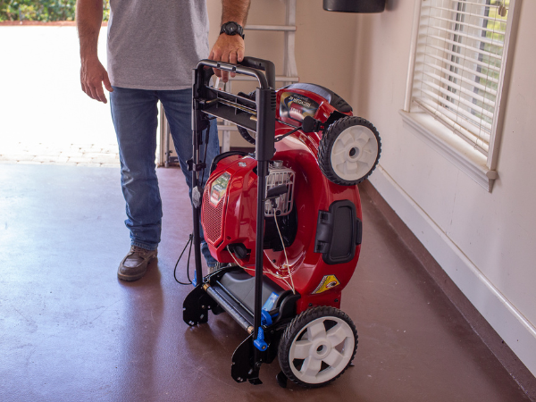 Person pushing a push mower cutting their lawn